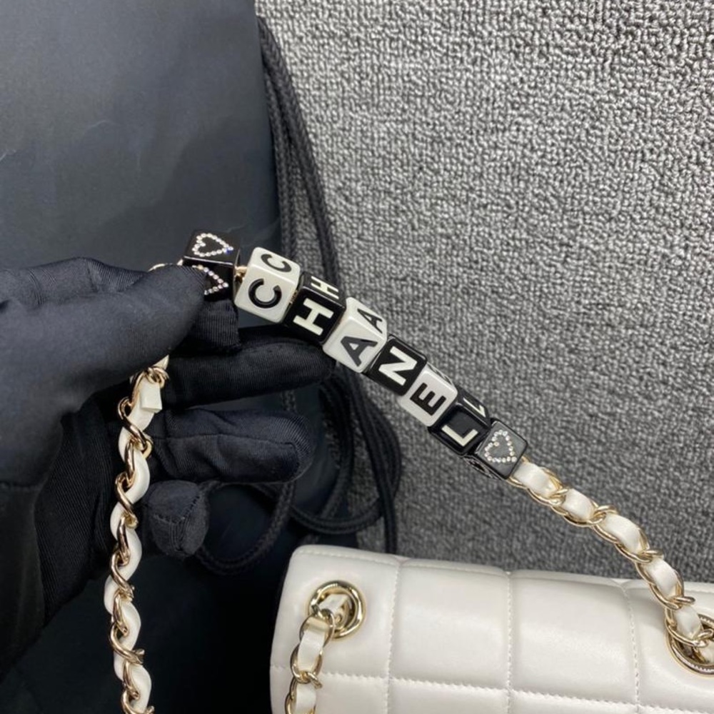 White dice Chanel small box bag in very good condition.